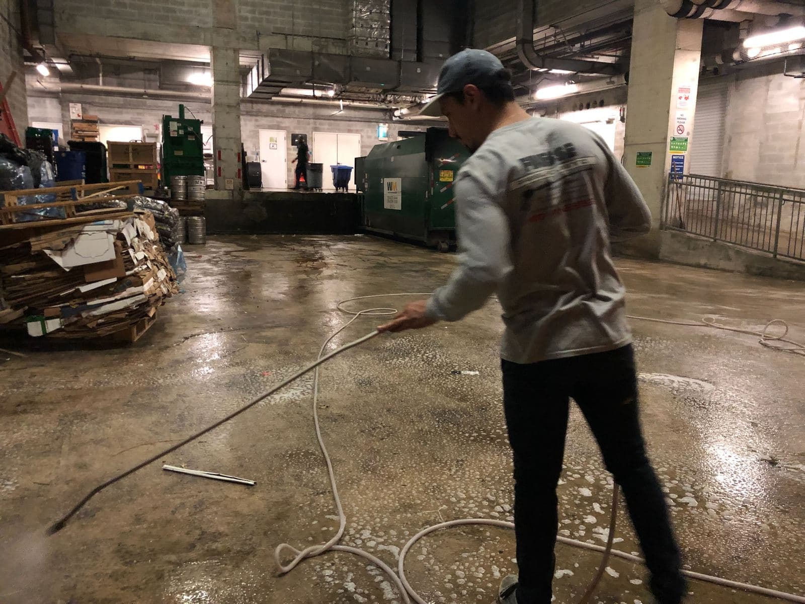 Crew pressure washing a warehouse floor — Finesse Cleaning, South Florida