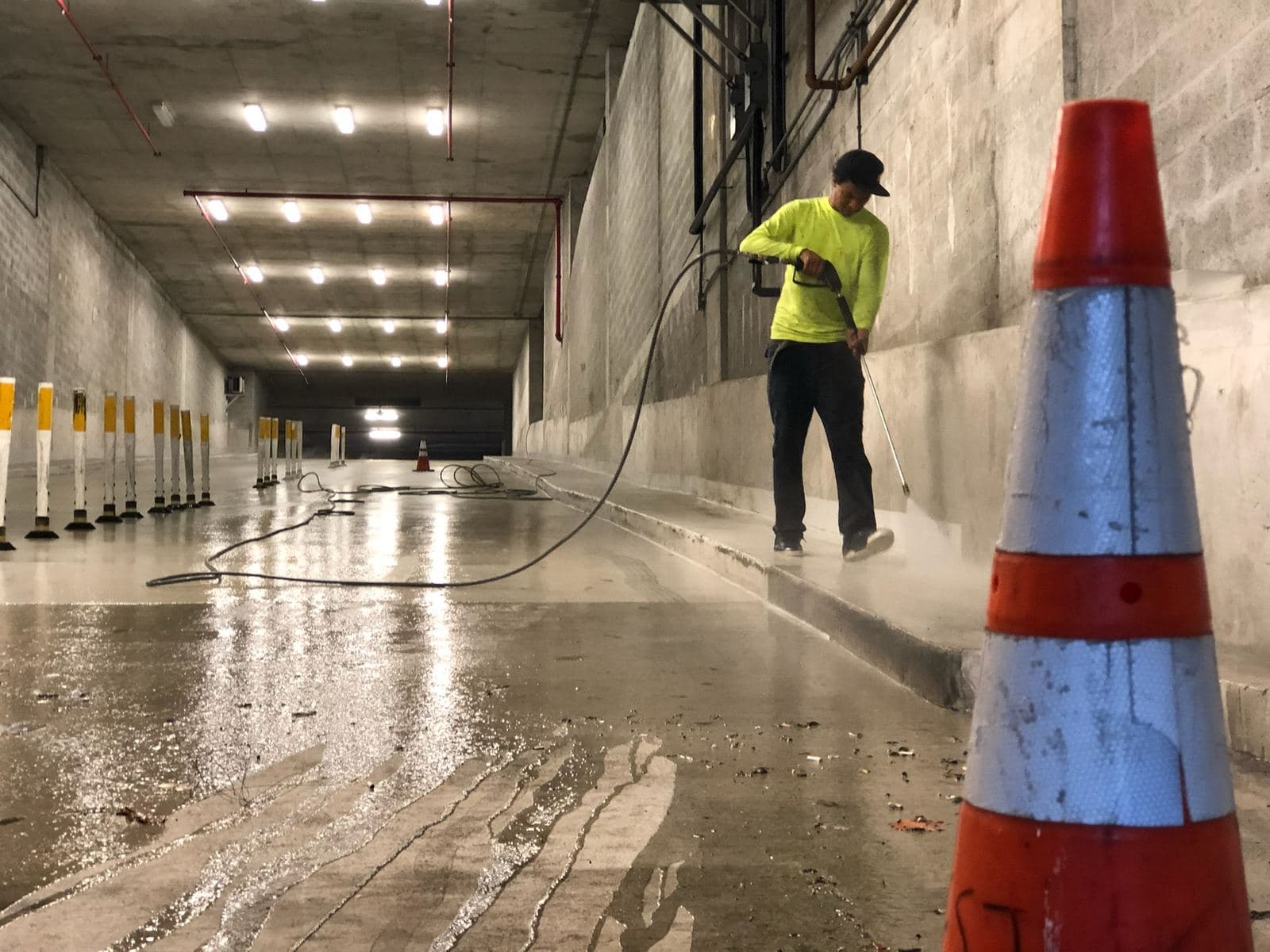 Crew pressure washing a parking garage wall — Finesse Cleaning, South Florida