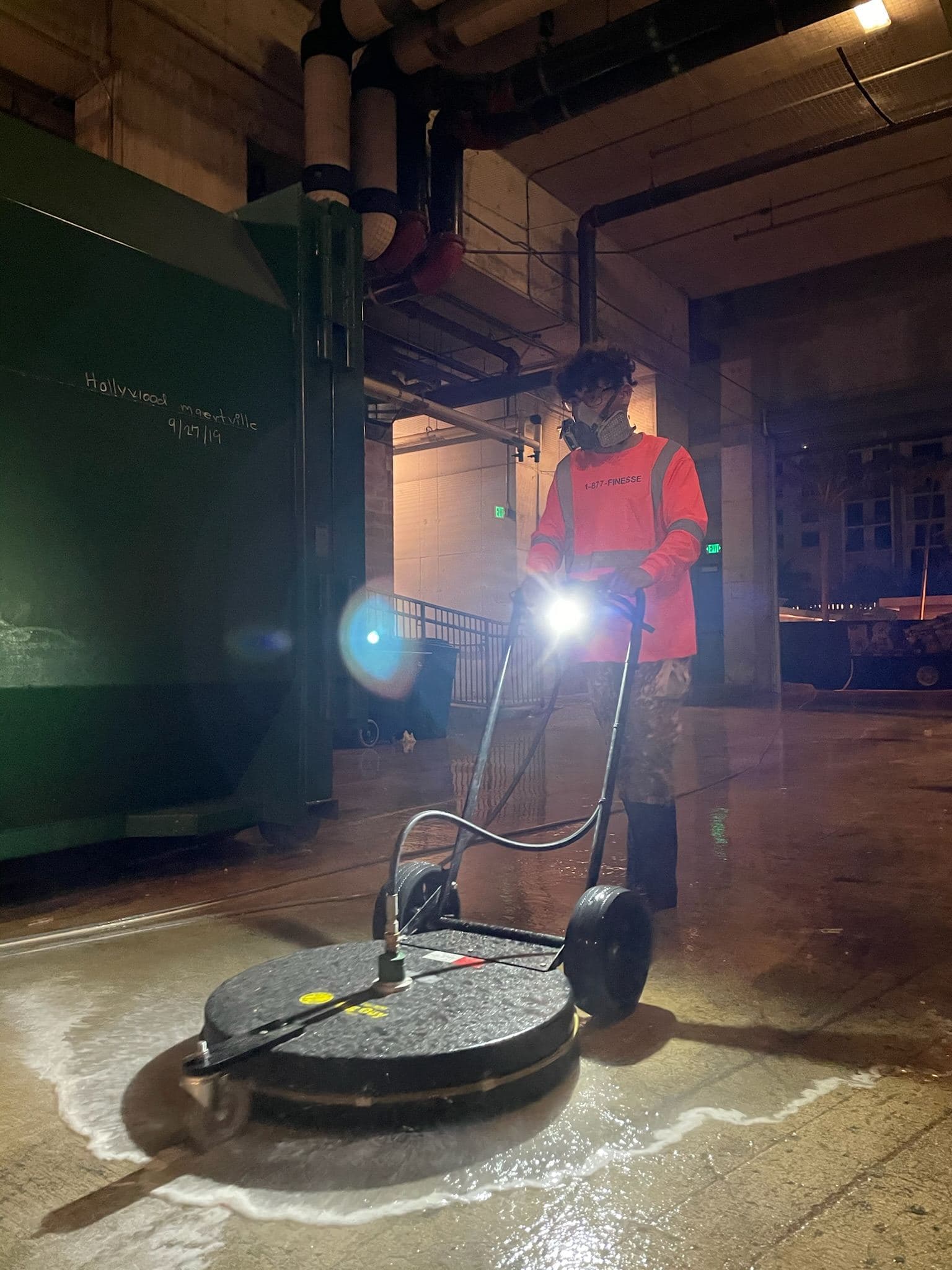 Crew pressure washing a commercial floor at night — Finesse Cleaning, South Florida