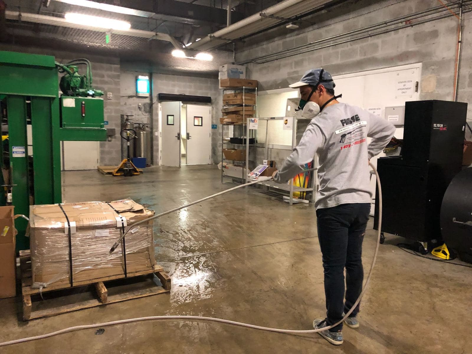 Crew pressure washing a warehouse with equipment — Finesse Cleaning, South Florida