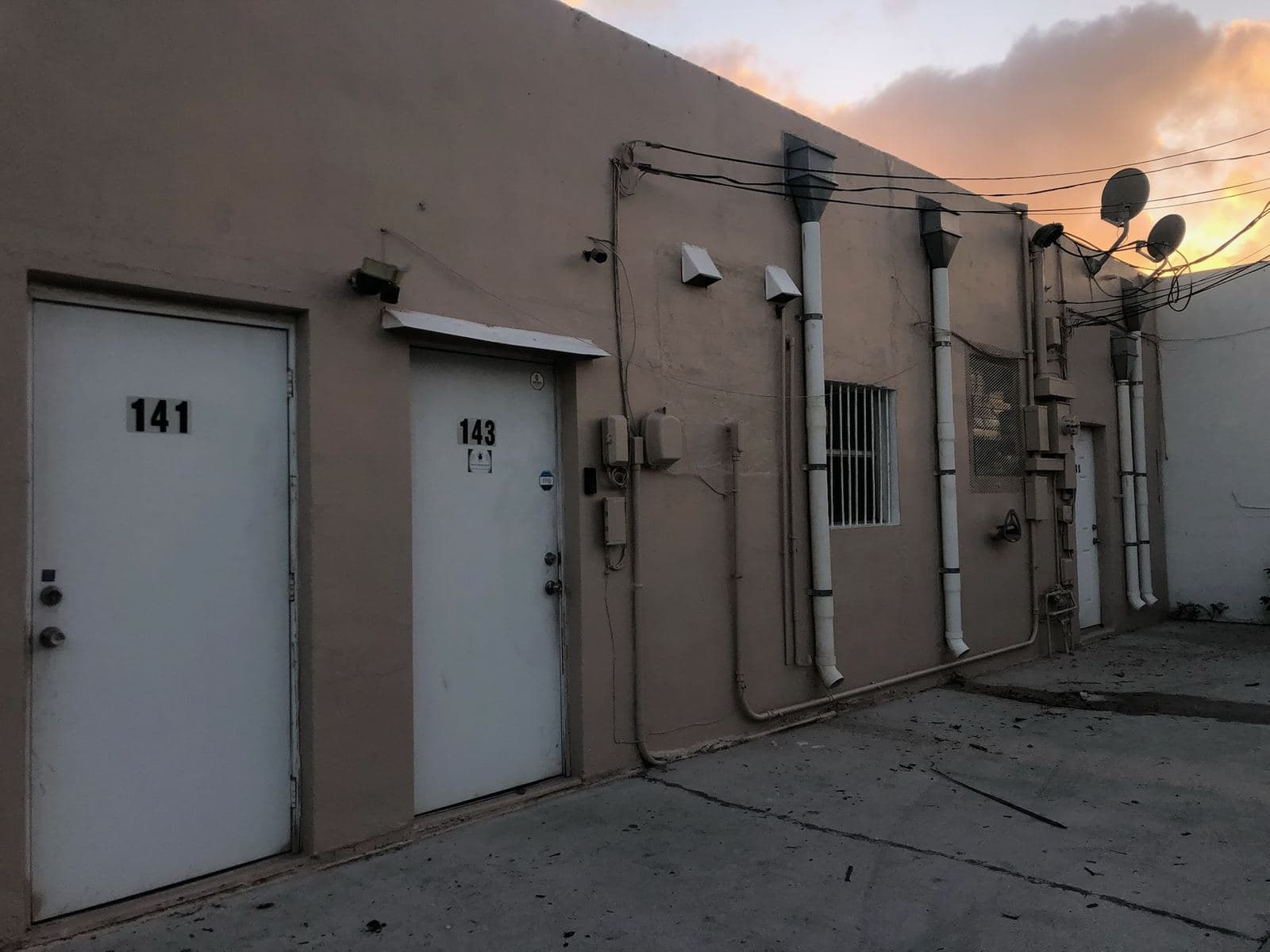 Exterior wall and doors of a commercial building after cleaning — Finesse Cleaning, South Florida