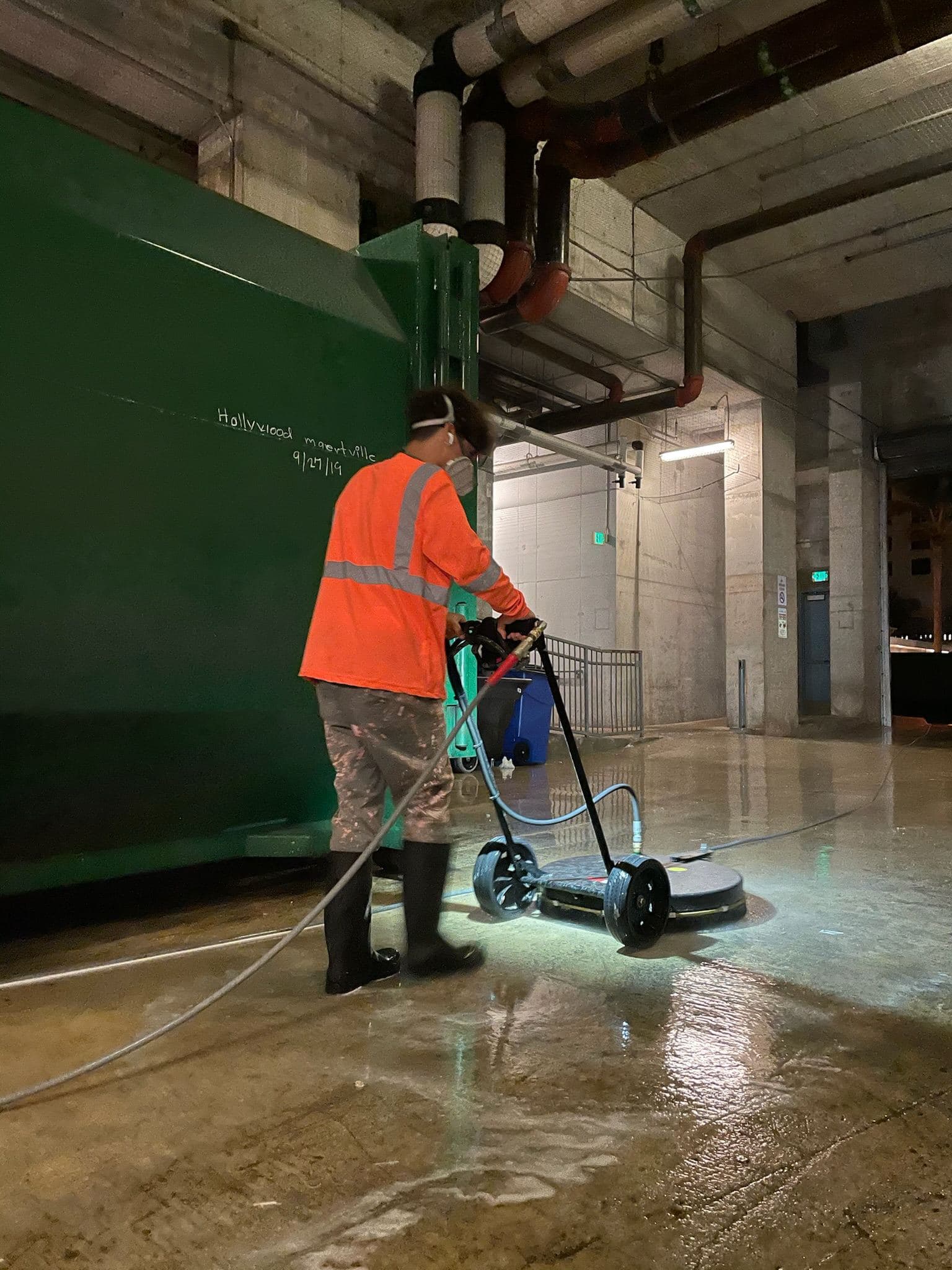 Crew pressure washing a warehouse floor — Finesse Cleaning, South Florida