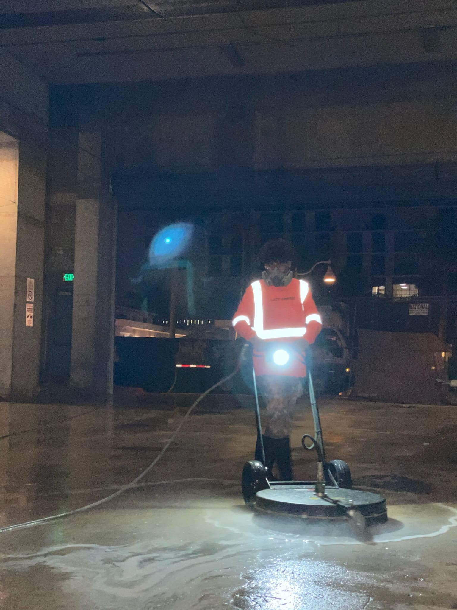 Crew pressure washing a garage floor at night — Finesse Cleaning, South Florida