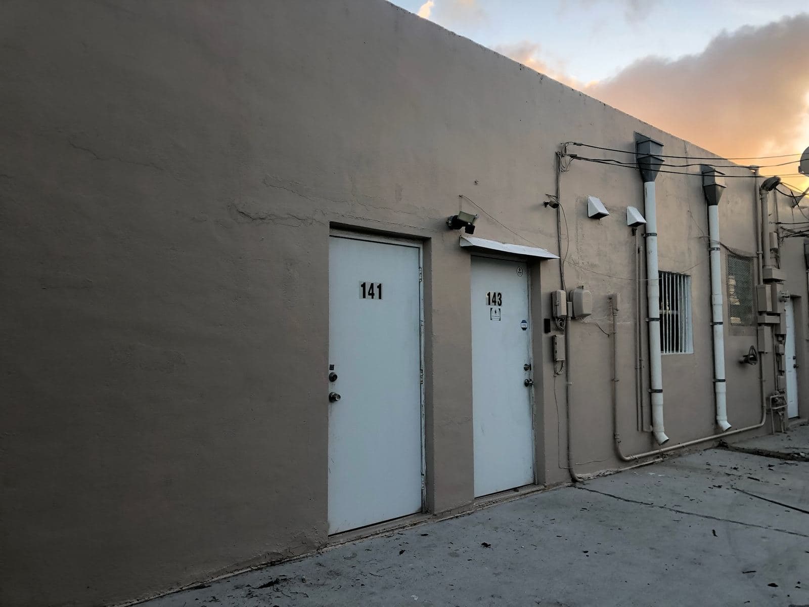 Exterior wall and doors of a commercial building at sunset — Finesse Cleaning, South Florida
