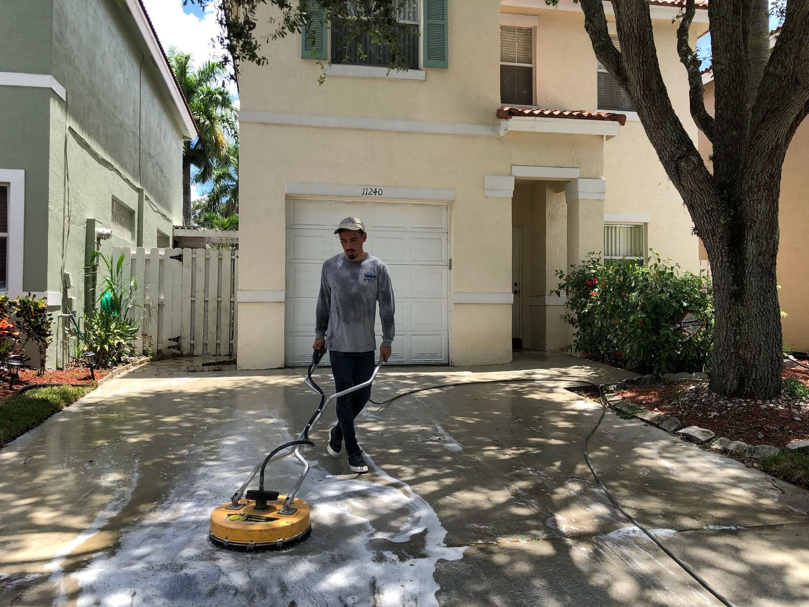 Crew pressure washing a brick paver driveway — Finesse Cleaning, South Florida