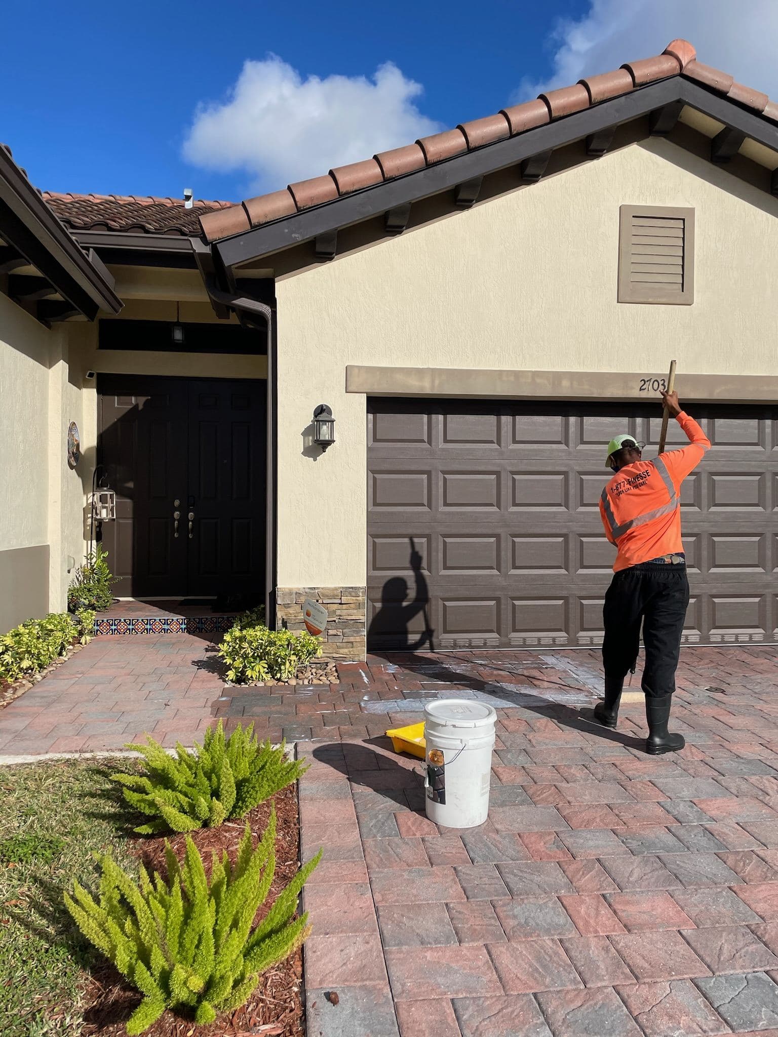Crew pressure washing a brick paver driveway — Finesse Cleaning, South Florida