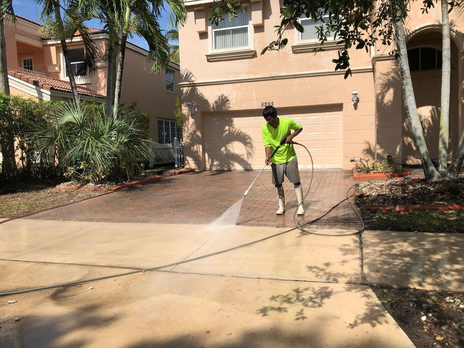 Crew pressure washing a driveway walkway — Finesse Cleaning, South Florida