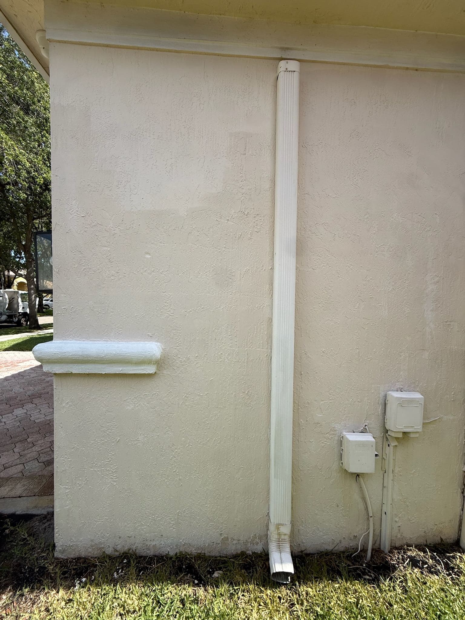 Stucco wall after pressure washing with a clean white finish — Finesse Cleaning, South Florida