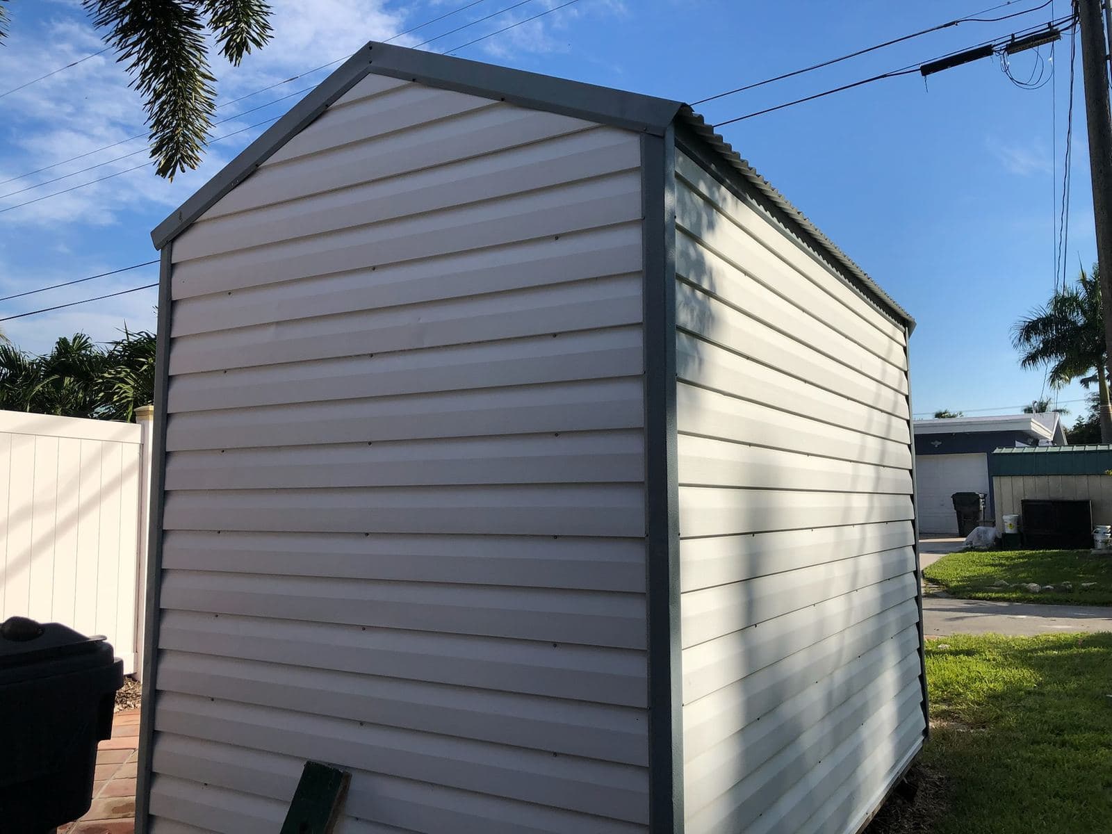 Exterior wall and metal roof of a shed after washing — Finesse Cleaning, South Florida
