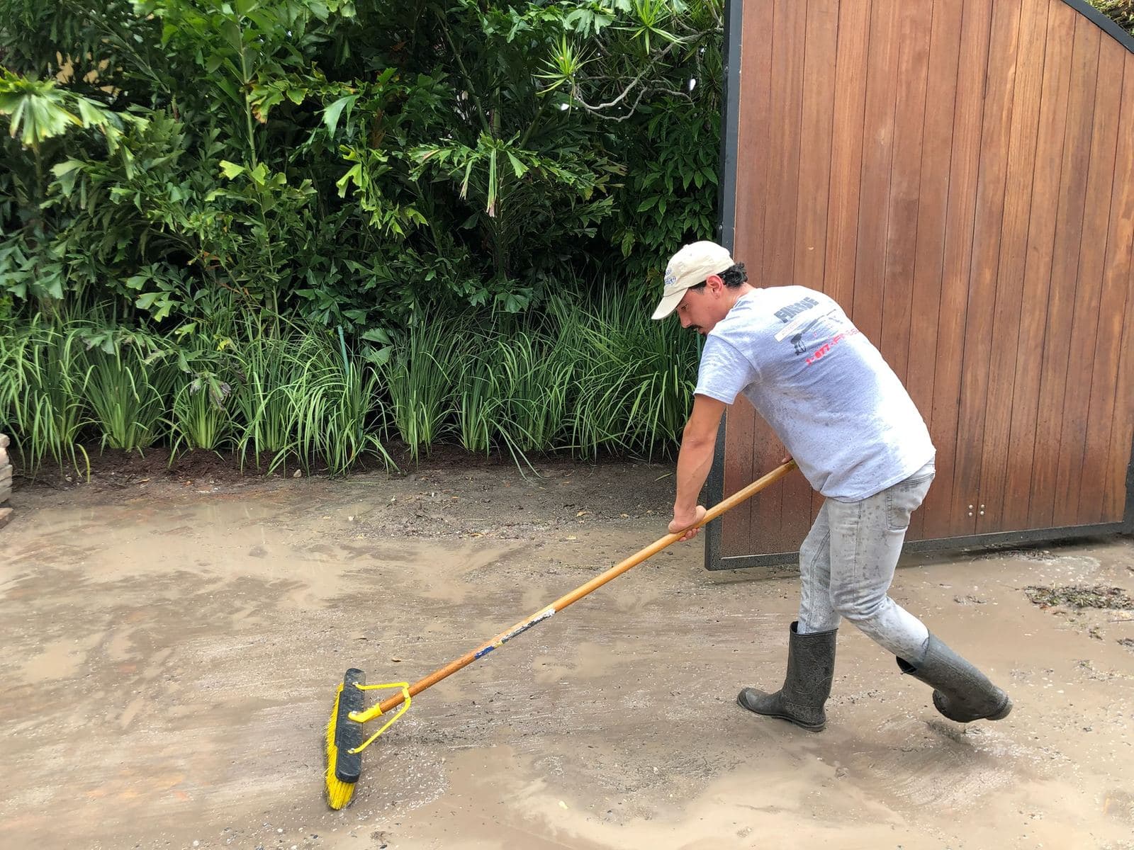 Crew scrubbing paver patio stones — Finesse Cleaning, South Florida