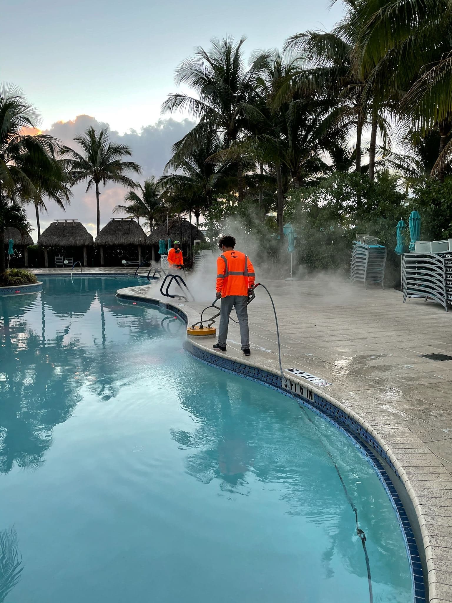 Crew washing a pool deck — Finesse Cleaning, South Florida