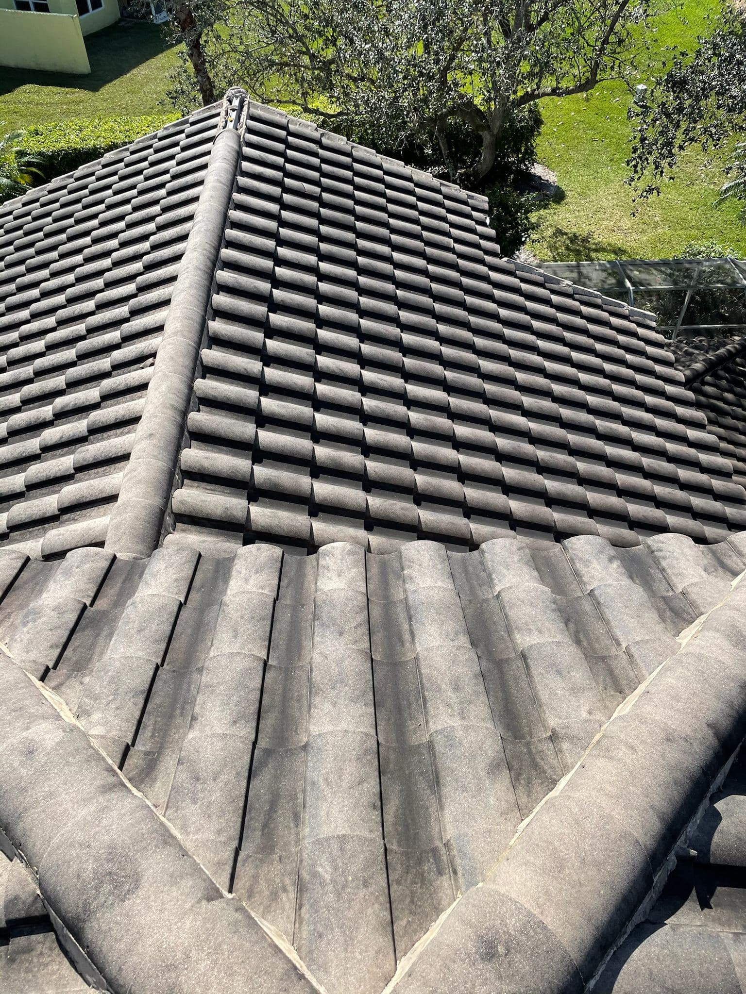 Tile roof covered in algae before soft washing — Finesse Cleaning, South Florida
