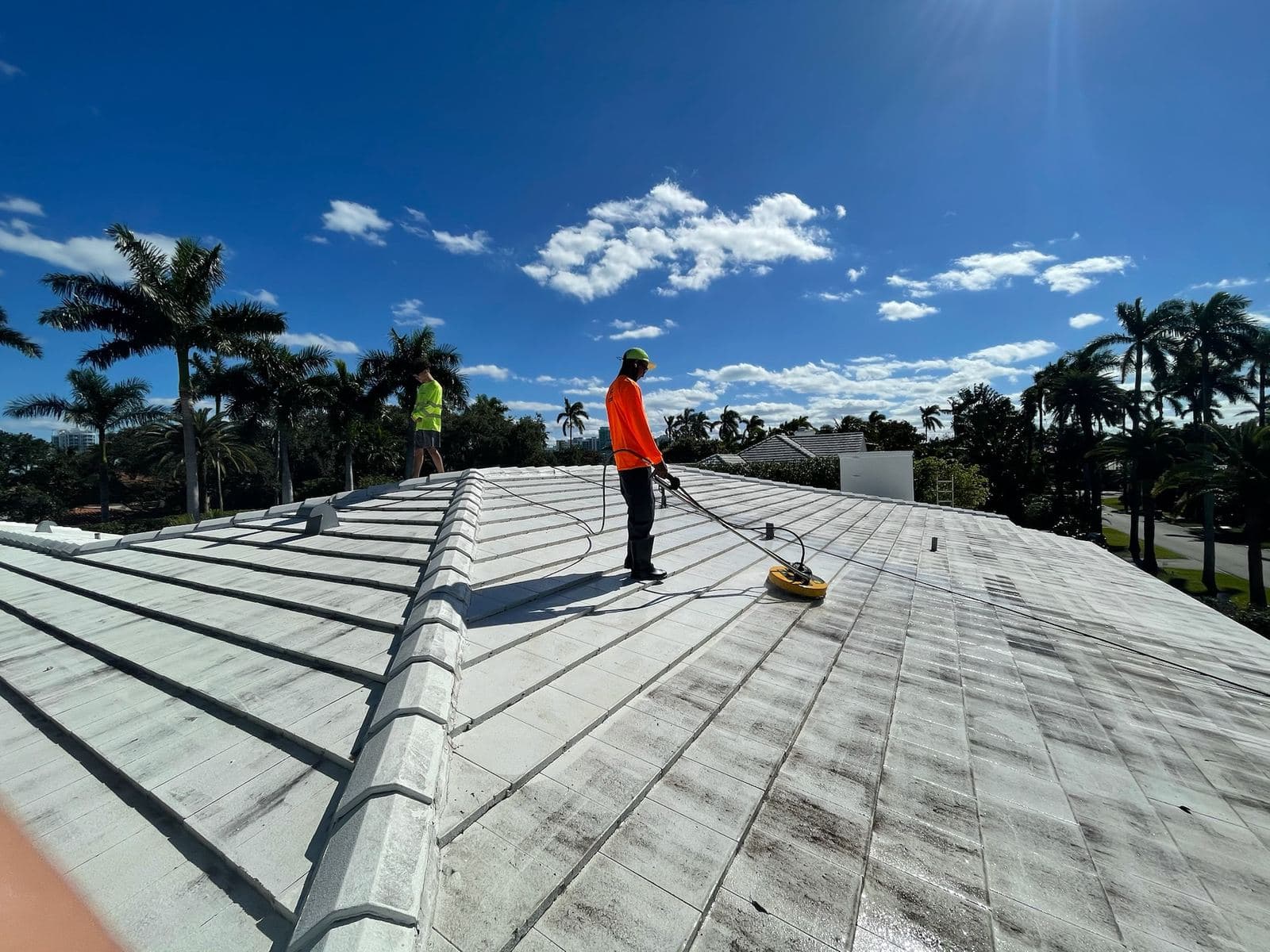 Crew soft washing a flat commercial roof — Finesse Cleaning, South Florida