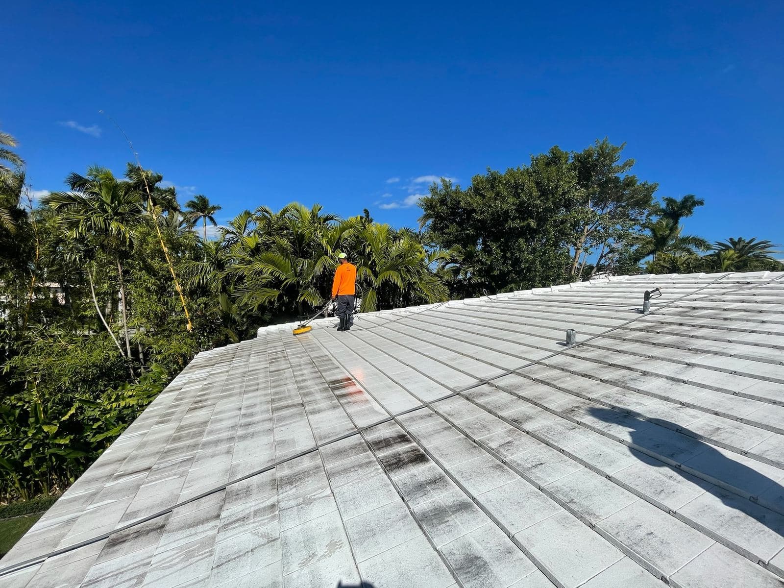 Crew walking a freshly cleaned metal roof — Finesse Cleaning, South Florida