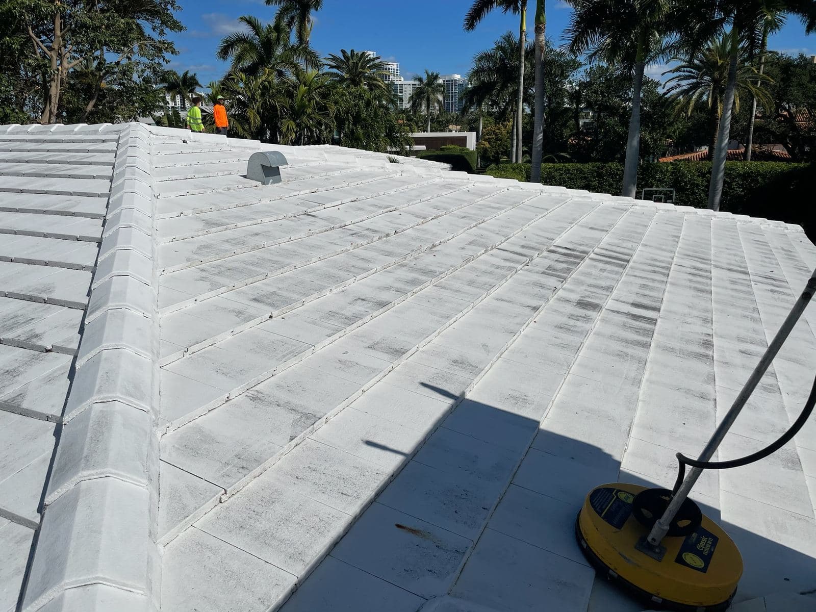 Crew soft washing a flat roof — Finesse Cleaning, South Florida