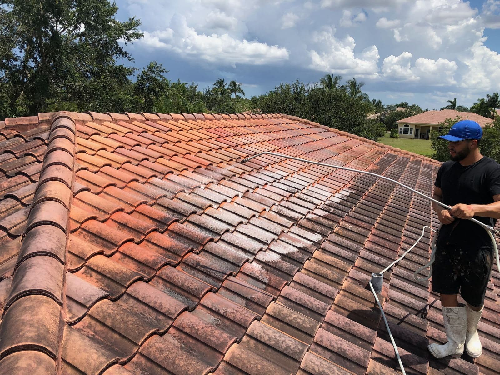 Crew soft washing a tile roof — Finesse Cleaning, South Florida