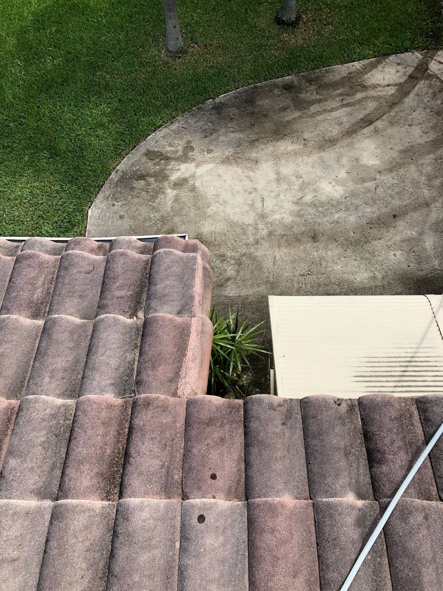Tile roof partially cleaned showing before and after — Finesse Cleaning, South Florida