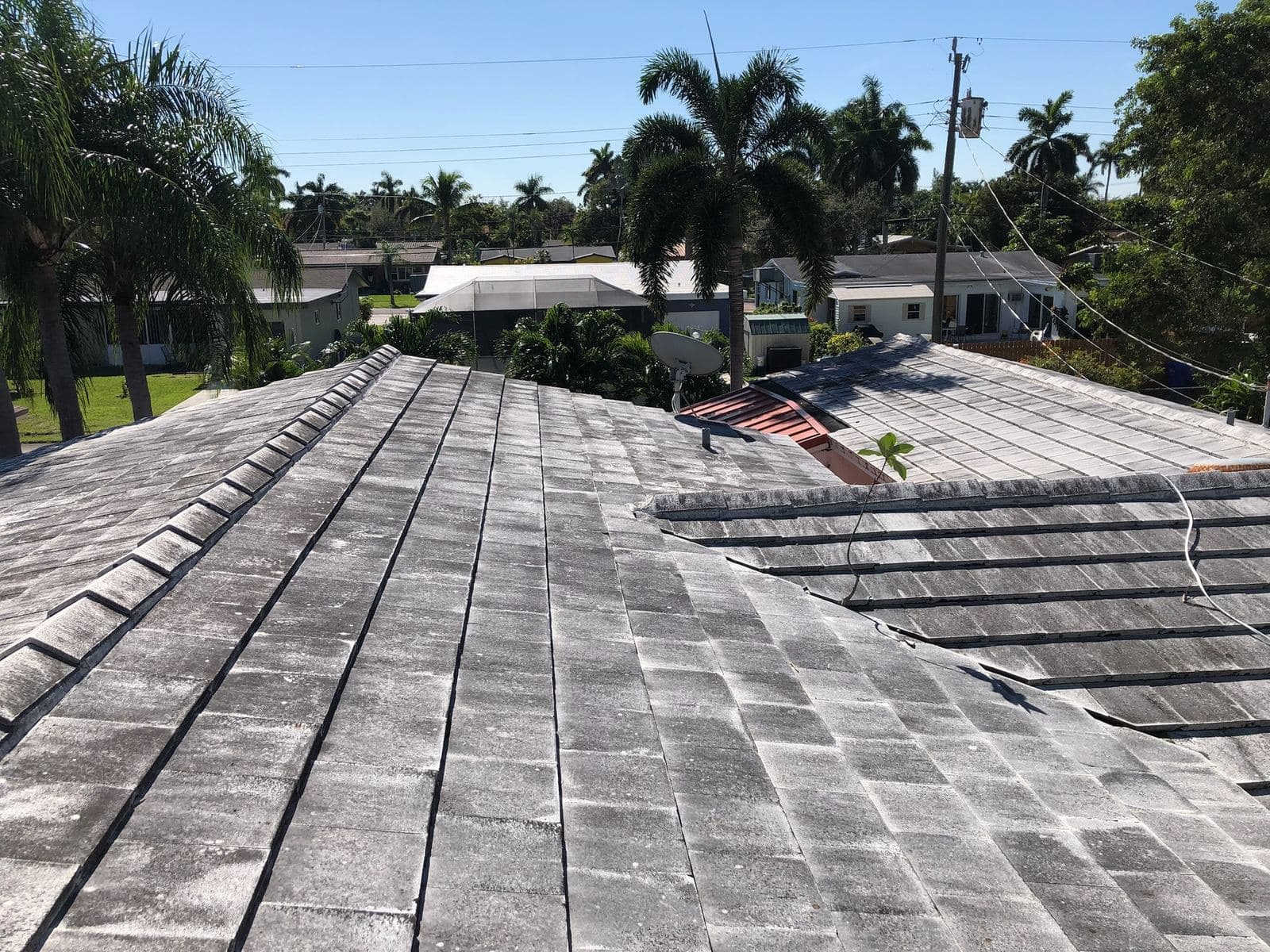 Crew soft washing a tile roof — Finesse Cleaning, South Florida