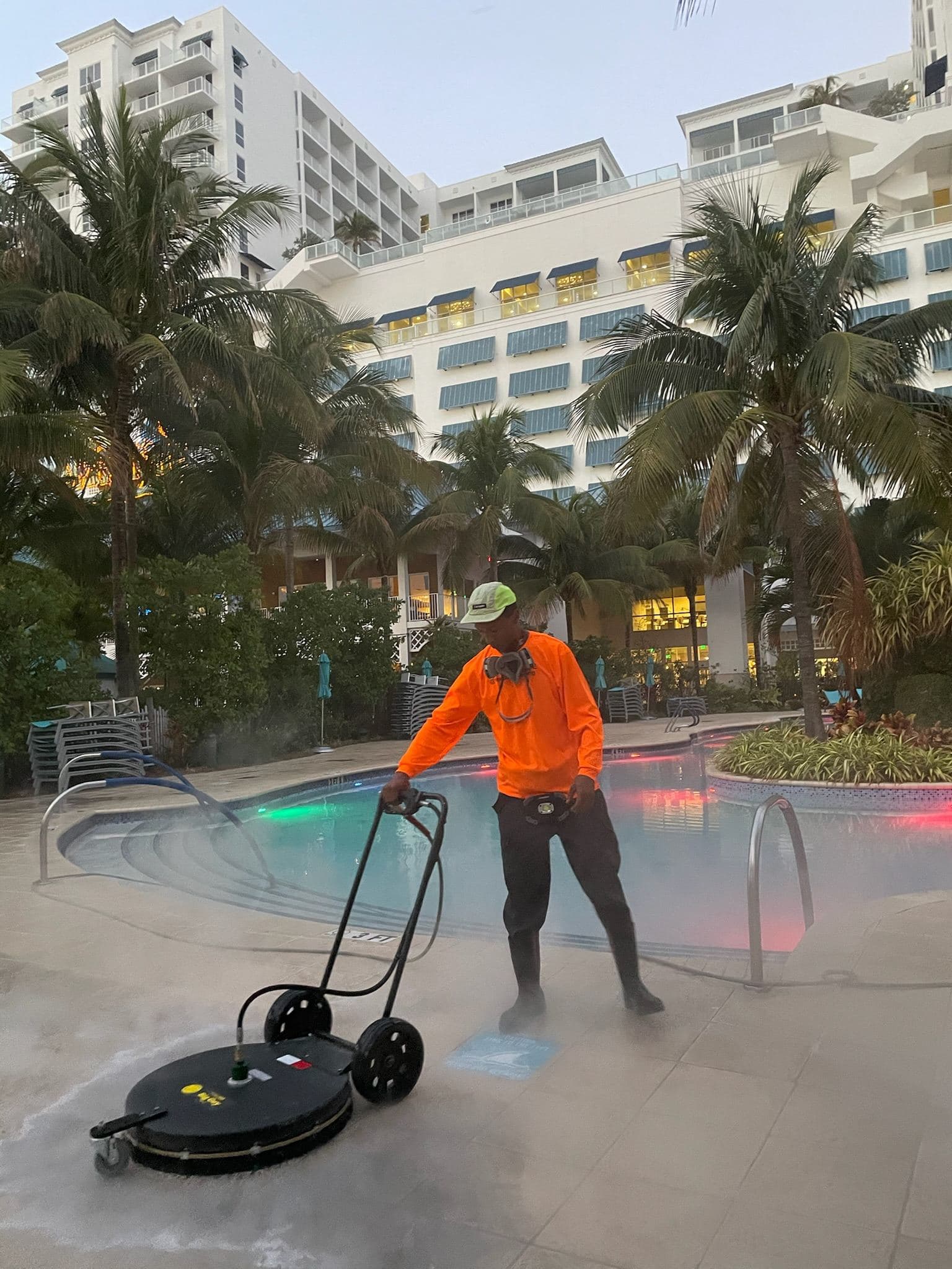 Crew soft washing a flat commercial roof — Finesse Cleaning, South Florida